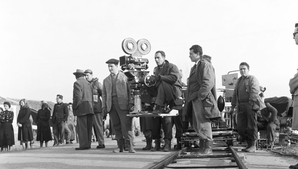 Italian director Michelangelo Antonioni at the camera on the set of his film 'Il Grido'. In the foreground, the camera rails. In the background, some of the crew. 1957 (Photo by Sergio StrizziReporters 